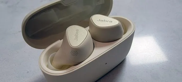 Jabra Elite 5 in charging case with packing tape stuck on inside of charging case.